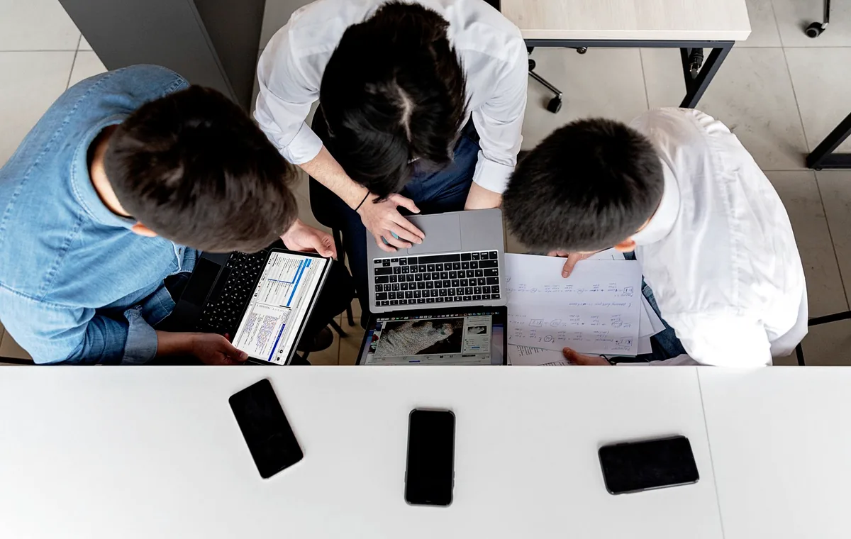 Professional team working together with laptops and documents