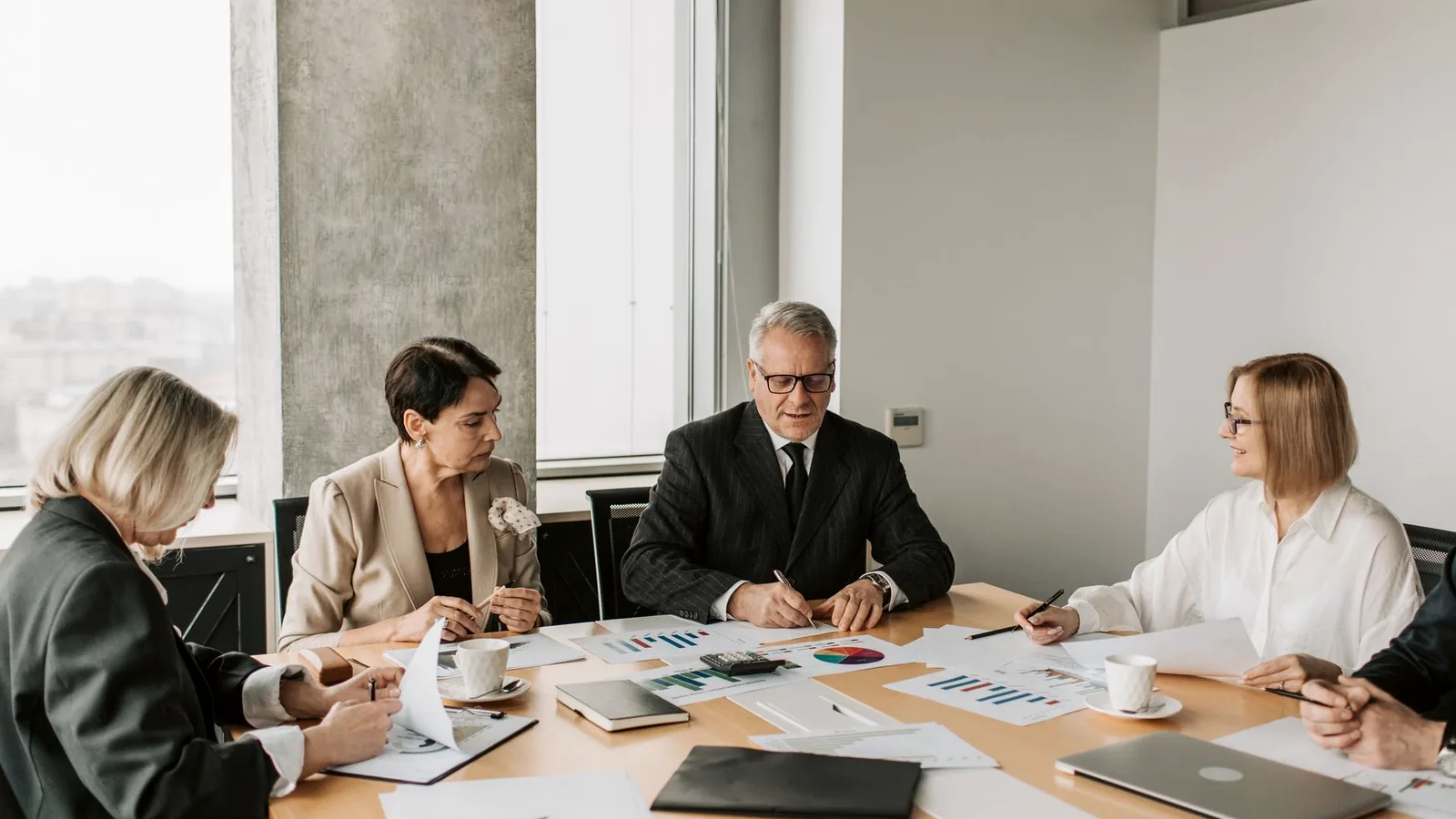 Business professionals reviewing documents during a meeting